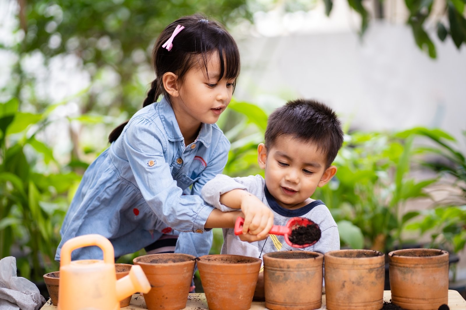 Two children planting seedlings